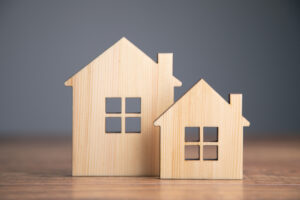 Closeup of two wood home models.