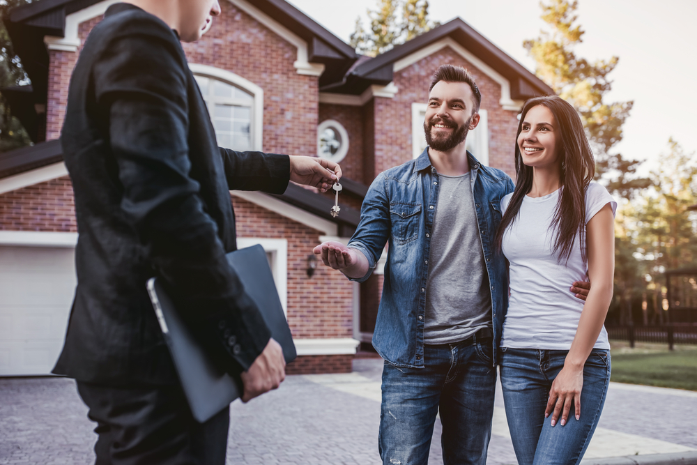 Home buyers accepting keys to their new home.