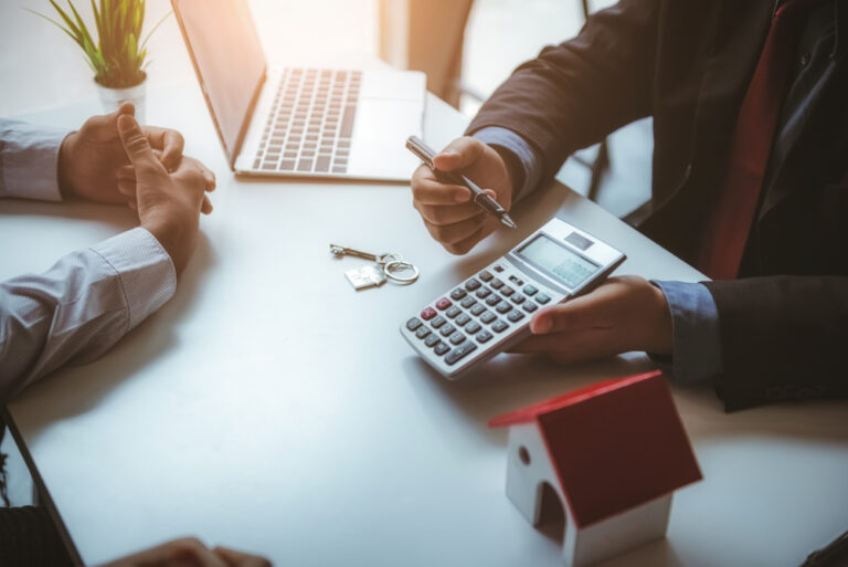real estate agent doing deal with clients at a desk